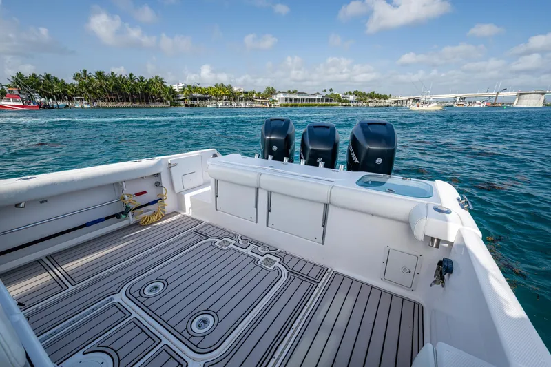 Kirby 107 Yacht Photos Pics 2014 Everglades 350LX boat with triple engines, docked near a scenic waterfront.