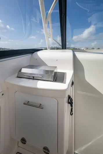 Kirby 107 Yacht Photos Pics 2014 Everglades 350LX boat interior with grill, white cabinetry, and clear sky view.