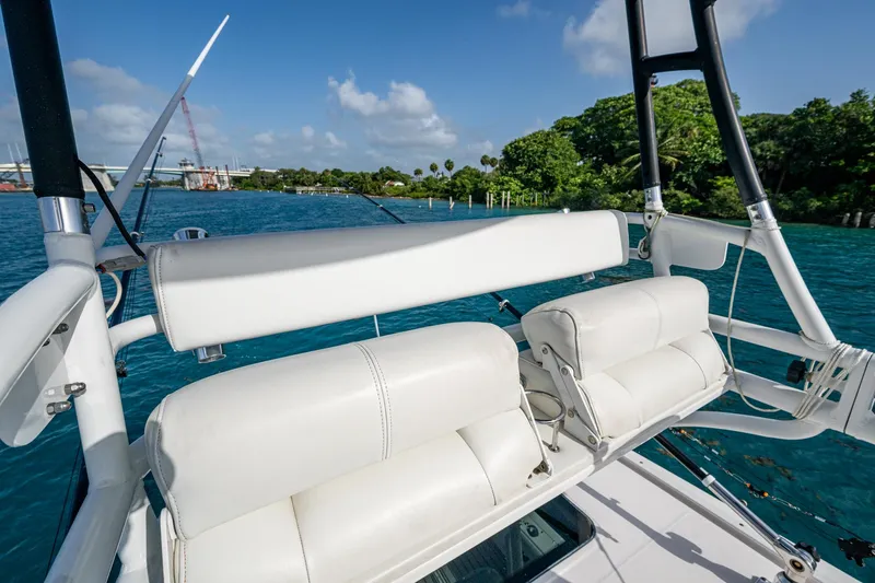 Kirby 107 Yacht Photos Pics 2014 Everglades 350LX boat with white seating, overlooking blue water and lush greenery.