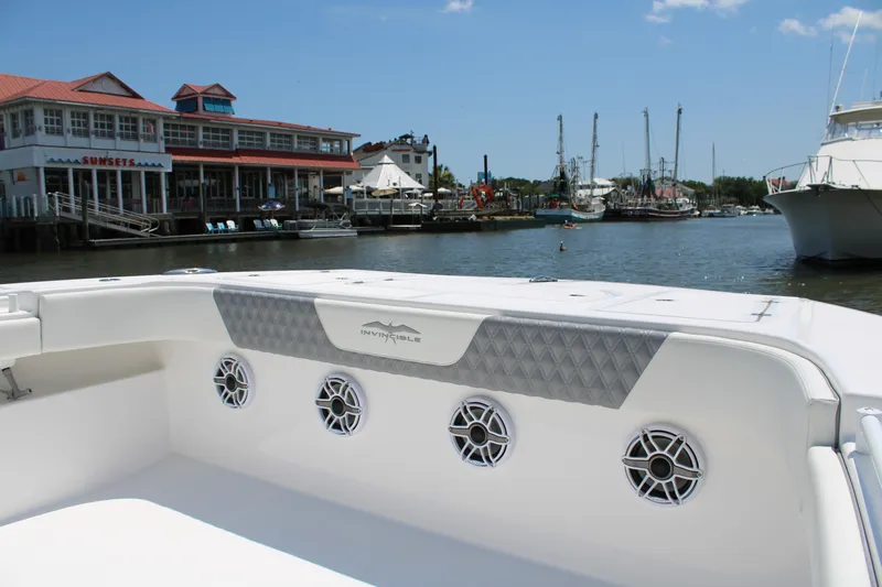  Yacht Photos Pics 2025 Invincible 35 Catamaran docked near waterfront buildings and boats.