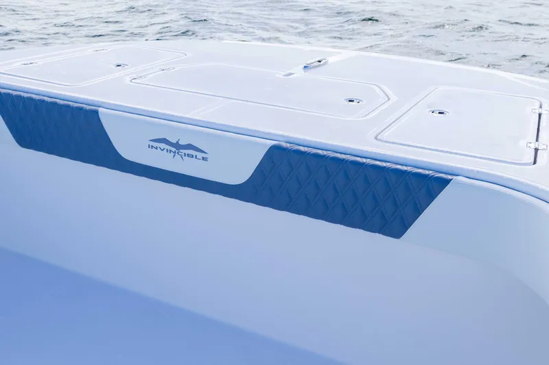  Yacht Photos Pics 2025 Invincible 35 Catamaran boat deck with logo, featuring sleek design and ocean backdrop.