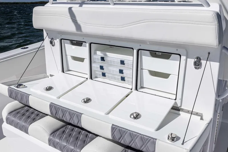  Yacht Photos Pics 2025 Invincible 35 Catamaran storage compartments with cushioned seating and ocean backdrop.