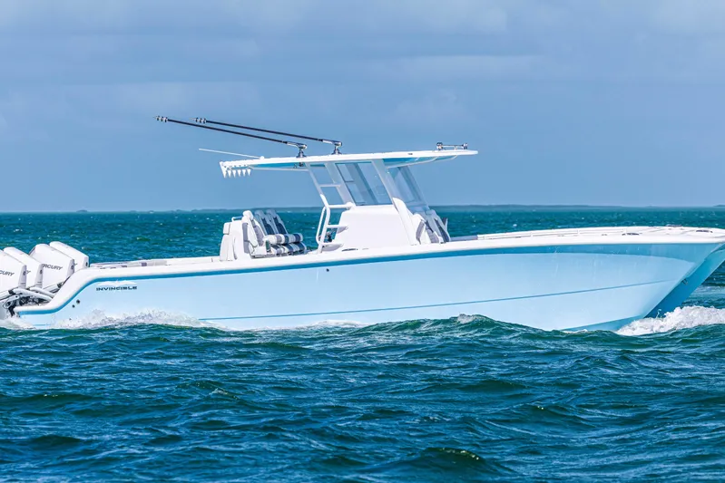  Yacht Photos Pics 2025 Invincible 35 Catamaran cruising on open water, showcasing sleek design and powerful engines.