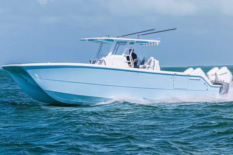  Yacht Photos Pics 2025 Invincible 35 Catamaran cruising on open water, showcasing sleek design and powerful engines.