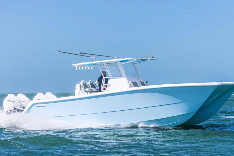  Yacht Photos Pics 2025 Invincible 35 Catamaran cruising on open water, showcasing sleek design and powerful engines.