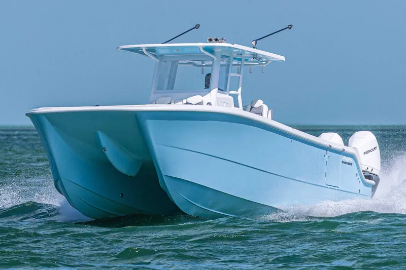  Yacht Photos Pics 2025 Invincible 35 Catamaran cruising on open water, showcasing sleek design and performance.