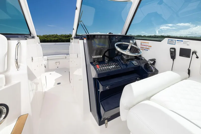  Yacht Photos Pics Manufacturer Provided Image: 2025 Pursuit DC 326 Dual Console boat interior with steering wheel and controls.