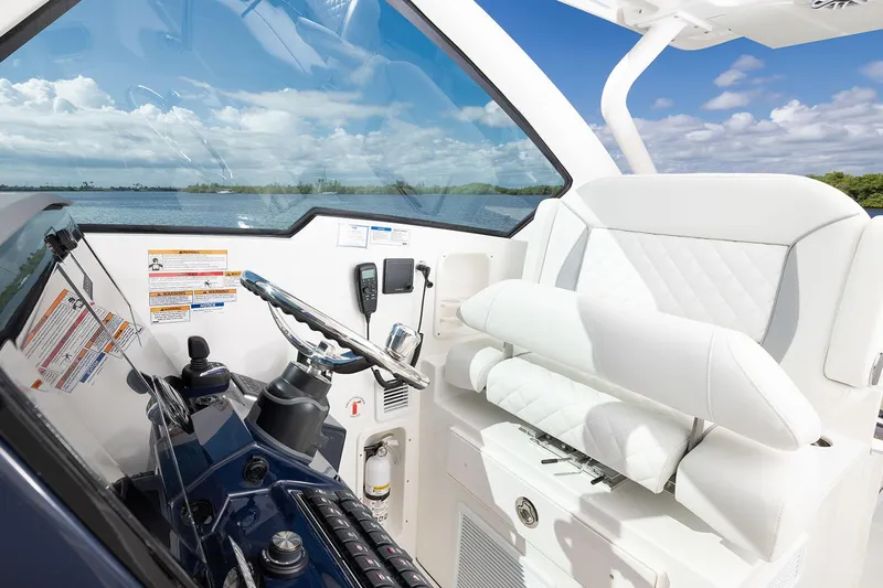  Yacht Photos Pics Manufacturer Provided Image: 2025 Pursuit DC 326 Dual Console boat interior with steering wheel and white seating.