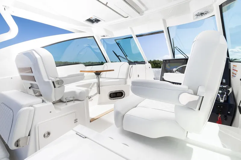  Yacht Photos Pics Manufacturer Provided Image: Interior of 2025 Pursuit DC 326 Dual Console boat with white seating and modern design.