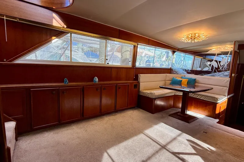 Moonlight Mist Yacht Photos Pics Luxurious 1987 Chris-Craft 500 Constellation yacht interior with elegant wood paneling and cozy seating.
