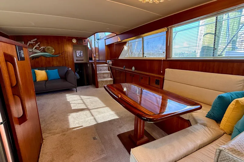 Moonlight Mist Yacht Photos Pics Luxurious 1987 Chris-Craft 500 Constellation yacht interior with elegant wood finishes and cozy seating.
