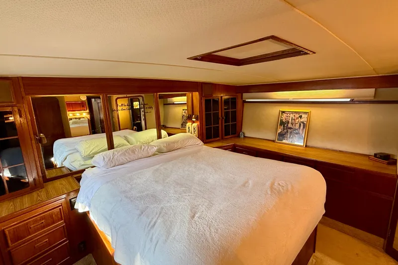 Moonlight Mist Yacht Photos Pics Luxurious bedroom interior of 1987 Chris-Craft 500 Constellation yacht with wood accents.
