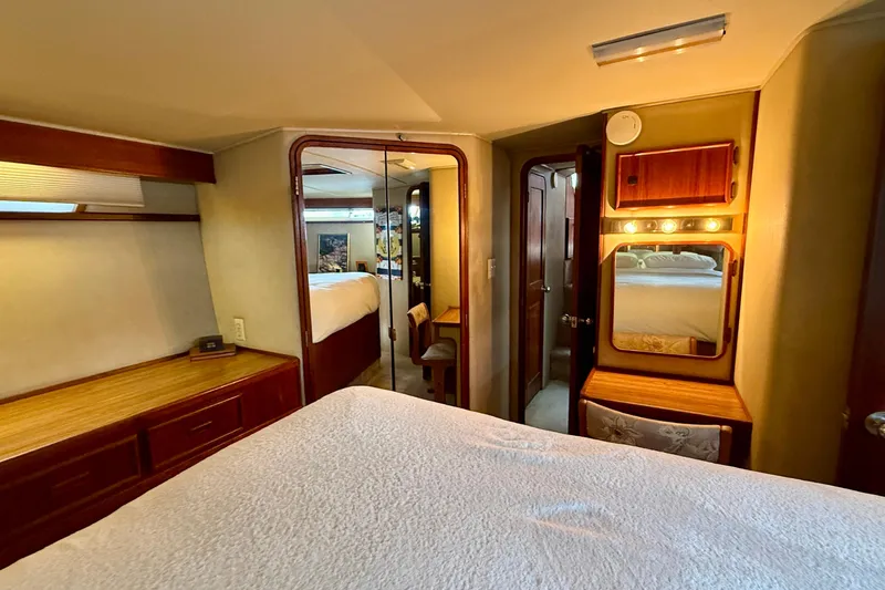 Moonlight Mist Yacht Photos Pics Interior of 1987 Chris-Craft 500 Constellation yacht bedroom with wood accents and vanity.