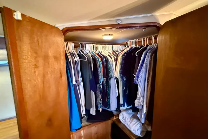 Moonlight Mist Yacht Photos Pics Closet inside 1987 Chris-Craft 500 Constellation yacht, filled with hanging clothes.