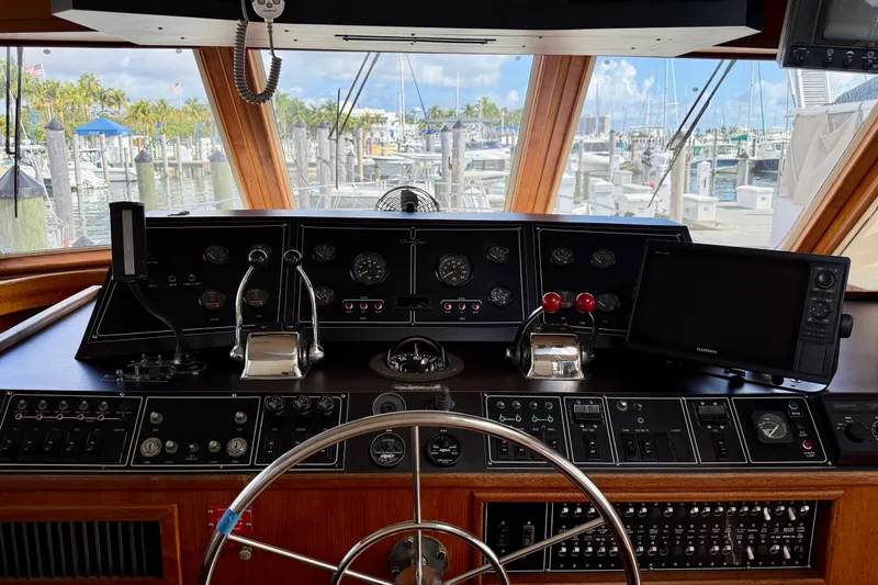 Moonlight Mist Yacht Photos Pics 1987 Chris-Craft 500 Constellation helm with navigation instruments and marina view.