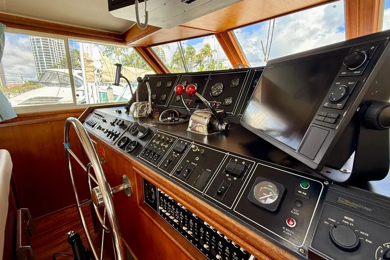 Moonlight Mist Yacht Photos Pics 1987 Chris-Craft 500 Constellation helm with navigation controls and steering wheel.
