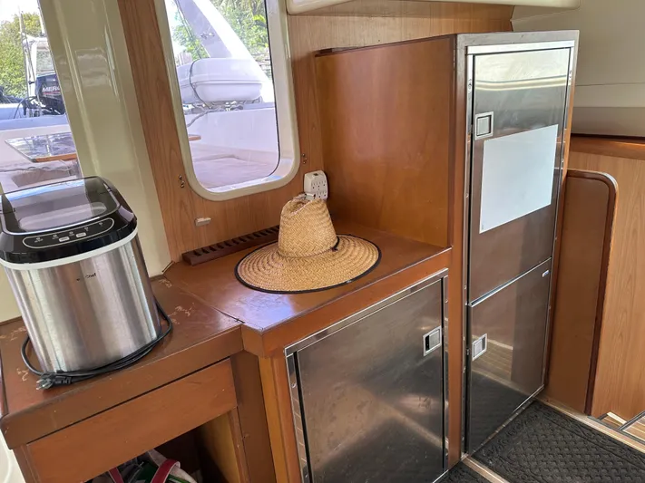 Bat Ha Yam Yacht Photos Pics Interior of a 2001 Leopard 47 yacht with wooden cabinetry and modern appliances.