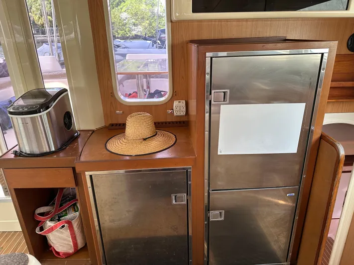 Bat Ha Yam Yacht Photos Pics Interior of 2001 Leopard 47 yacht with kitchen appliances and a straw hat.