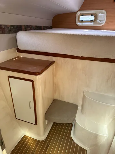 Bat Ha Yam Yacht Photos Pics Interior of 2001 Leopard 47 yacht with wooden steps and compact storage.