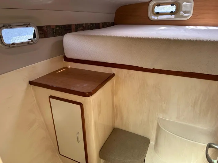 Bat Ha Yam Yacht Photos Pics 2001 Leopard 47 interior cabin with bed, storage, and window.