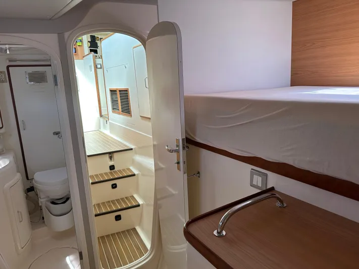 Bat Ha Yam Yacht Photos Pics Interior of 2001 Leopard 47 yacht showing stairs, cabin, and bathroom.