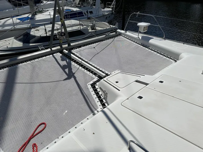 Bat Ha Yam Yacht Photos Pics Catamaran deck with netting, Leopard 47 model, 2001, docked in marina.