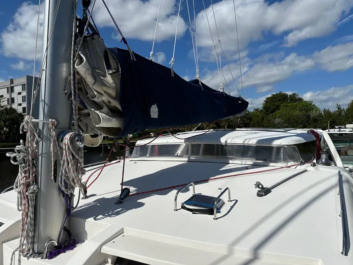Bat Ha Yam Yacht Photos Pics 2001 Leopard 47 catamaran deck with sails, under a clear blue sky.