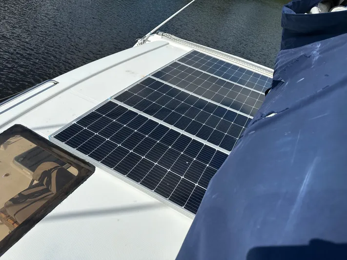 Bat Ha Yam Yacht Photos Pics Solar panels on a 2001 Leopard 47 catamaran deck, near water.