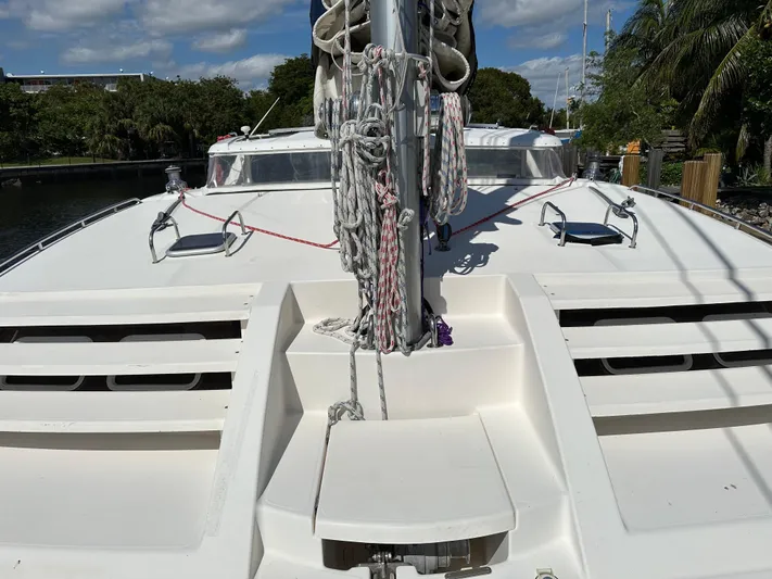 Bat Ha Yam Yacht Photos Pics 2001 Leopard 47 catamaran deck with rigging and hatches, docked under a clear sky.