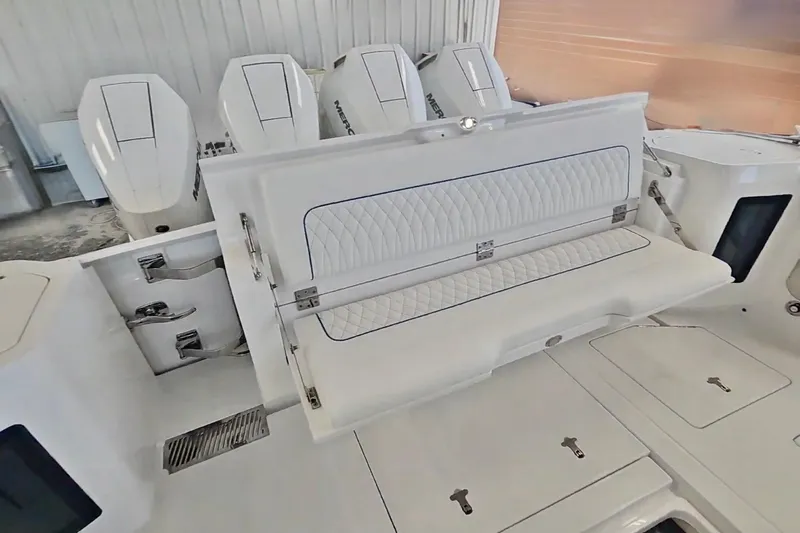  Yacht Photos Pics 2025 Intrepid 43 Nomad SE boat interior with foldable seating and multiple outboard engines.
