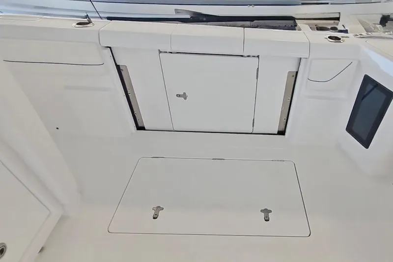  Yacht Photos Pics 2025 Intrepid 43 Nomad SE boat interior with storage compartments and control panel.