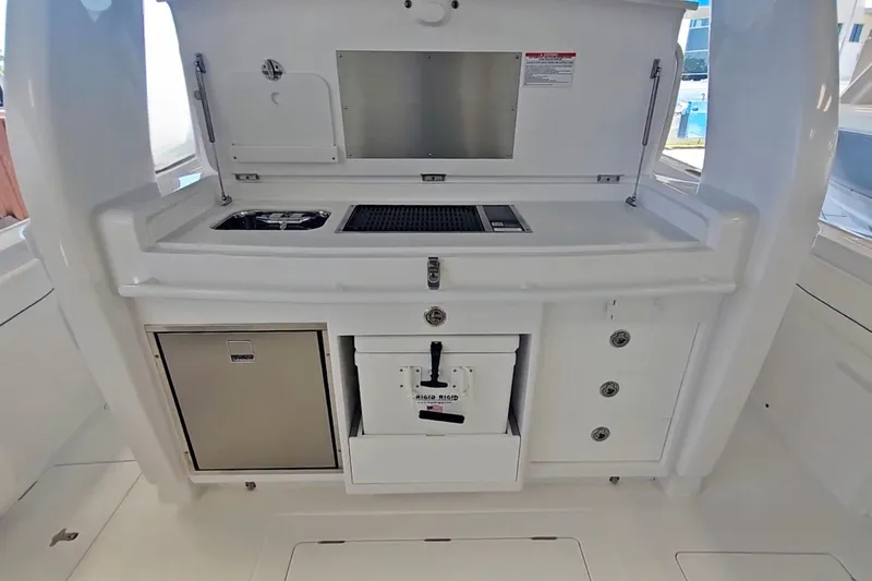  Yacht Photos Pics 2025 Intrepid 43 Nomad SE boat galley with grill, sink, and storage compartments.