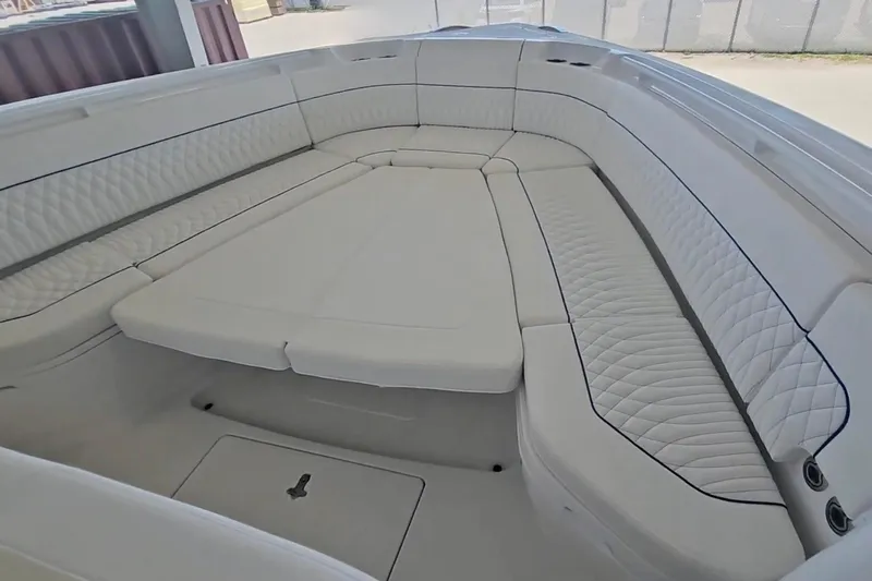  Yacht Photos Pics Luxurious seating area on 2025 Intrepid 43 Nomad SE boat, featuring elegant white upholstery.