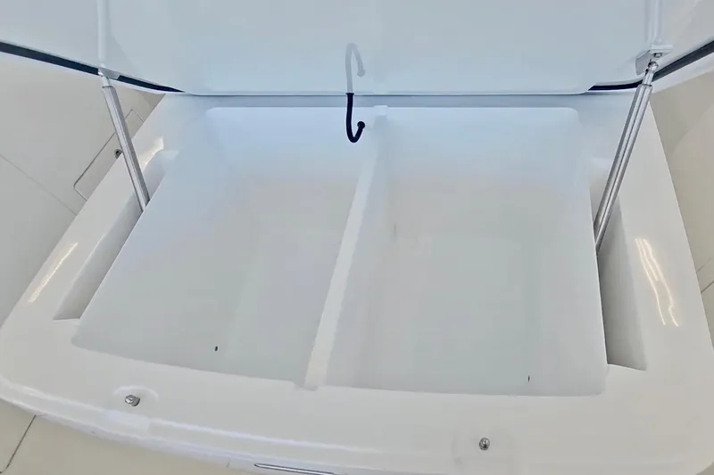  Yacht Photos Pics Open storage compartment on 2025 Intrepid 43 Nomad SE boat, featuring dual sections.