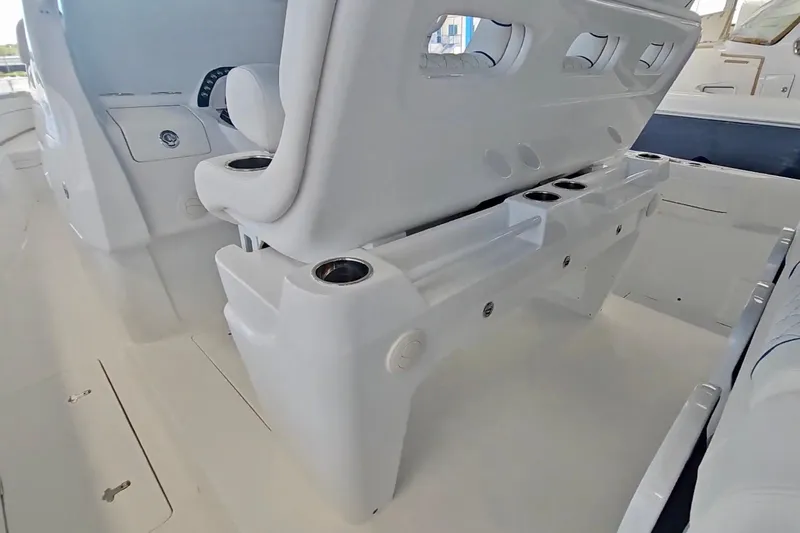  Yacht Photos Pics 2025 Intrepid 43 Nomad SE boat interior with white seating and cup holders.
