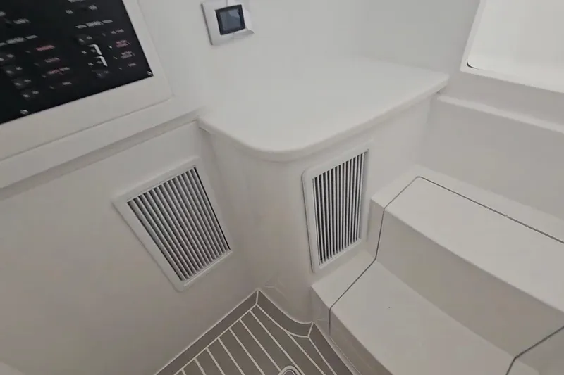  Yacht Photos Pics Interior of 2025 Intrepid 43 Nomad SE boat, featuring sleek design and modern controls.
