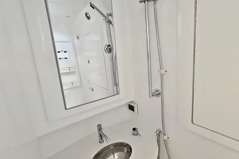  Yacht Photos Pics Bathroom interior of 2025 Intrepid 43 Nomad SE yacht, featuring modern fixtures and sleek design.