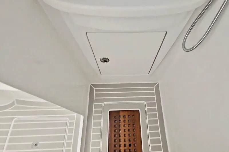  Yacht Photos Pics Interior view of 2025 Intrepid 43 Nomad SE boat, featuring sleek design and wooden flooring.