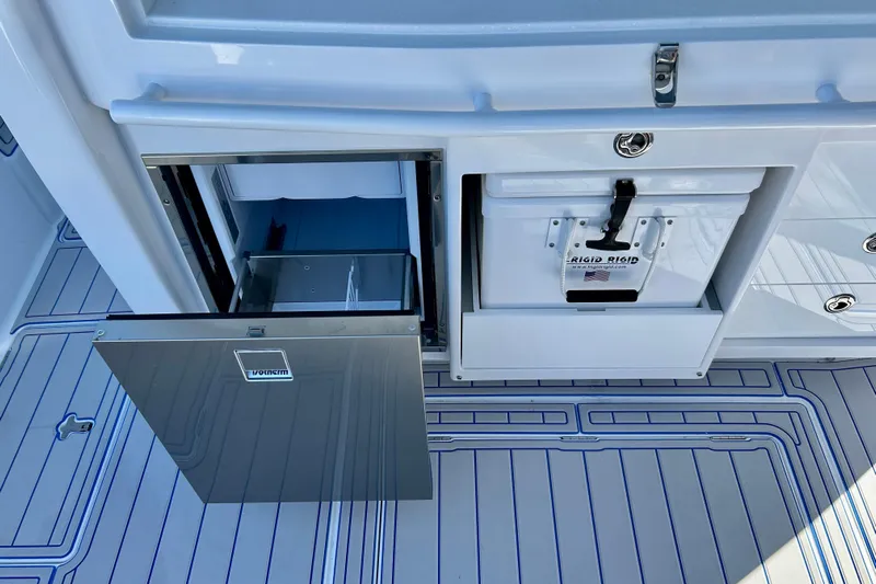 La Tuya Yacht Photos Pics 2025 Intrepid 43 Nomad SE boat interior with cooler and storage compartments.