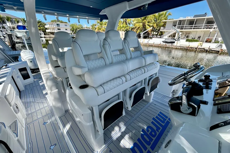 La Tuya Yacht Photos Pics Luxurious interior of 2025 Intrepid 43 Nomad SE boat with plush seating and modern helm.