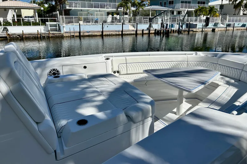 La Tuya Yacht Photos Pics Luxurious seating area on 2025 Intrepid 43 Nomad SE boat, docked by waterfront homes.