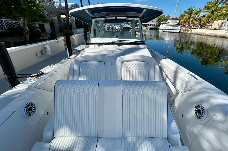 La Tuya Yacht Photos Pics 2025 Intrepid 43 Nomad SE luxury boat interior with white seating and waterfront view.