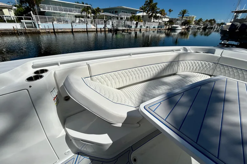 La Tuya Yacht Photos Pics Luxurious seating area on 2025 Intrepid 43 Nomad SE yacht, docked by waterfront homes.