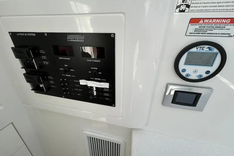 La Tuya Yacht Photos Pics Control panel of 2025 Intrepid 43 Nomad SE boat, featuring voltage and load current displays.