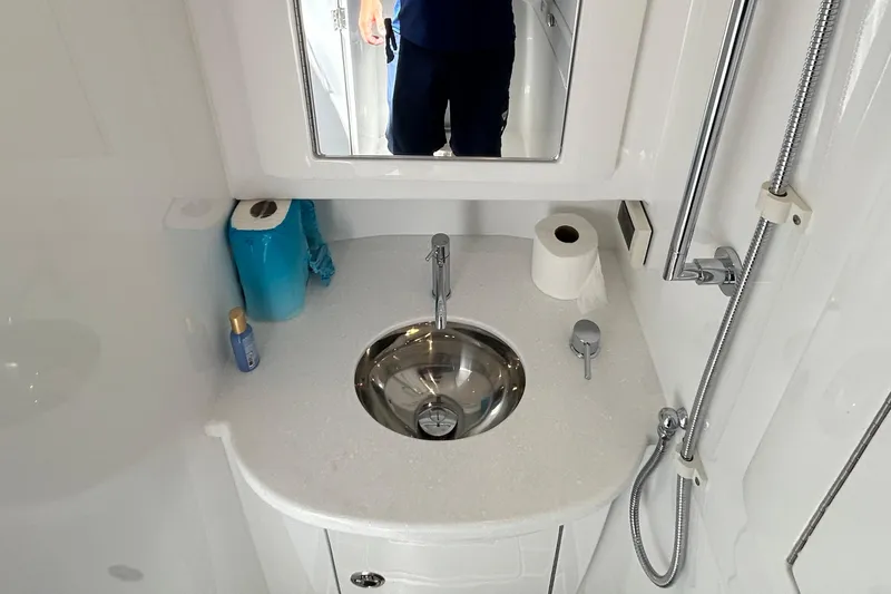 La Tuya Yacht Photos Pics Compact bathroom in 2025 Intrepid 43 Nomad SE with sink, mirror, and shower.