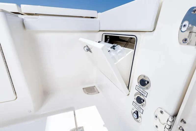  Yacht Photos Pics Manufacturer Provided Image: 2025 Pursuit OS 445 Offshore boat compartment with fresh and raw water controls.