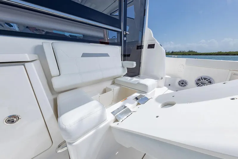  Yacht Photos Pics Manufacturer Provided Image: 2025 Pursuit OS 445 Offshore boat interior with white seating and ocean view.