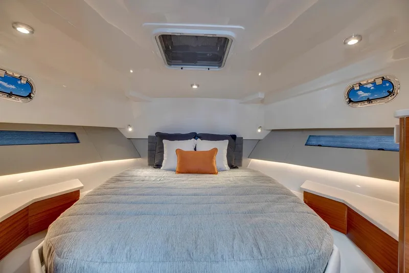  Yacht Photos Pics Manufacturer Provided Image: Luxurious cabin interior of 2025 Pursuit OS 445 Offshore yacht with cozy bedding.