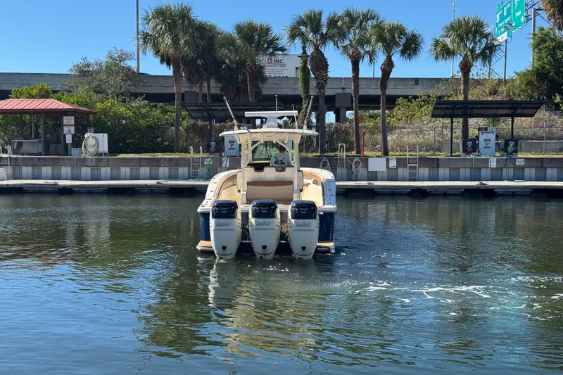  Yacht Photos Pics 2019 Scout 355 LXF boat with triple engines docked near palm trees.