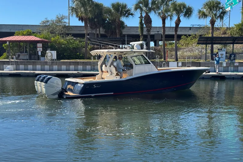  Yacht Photos Pics 2019 Scout 355 LXF boat docked near palm trees and marina.